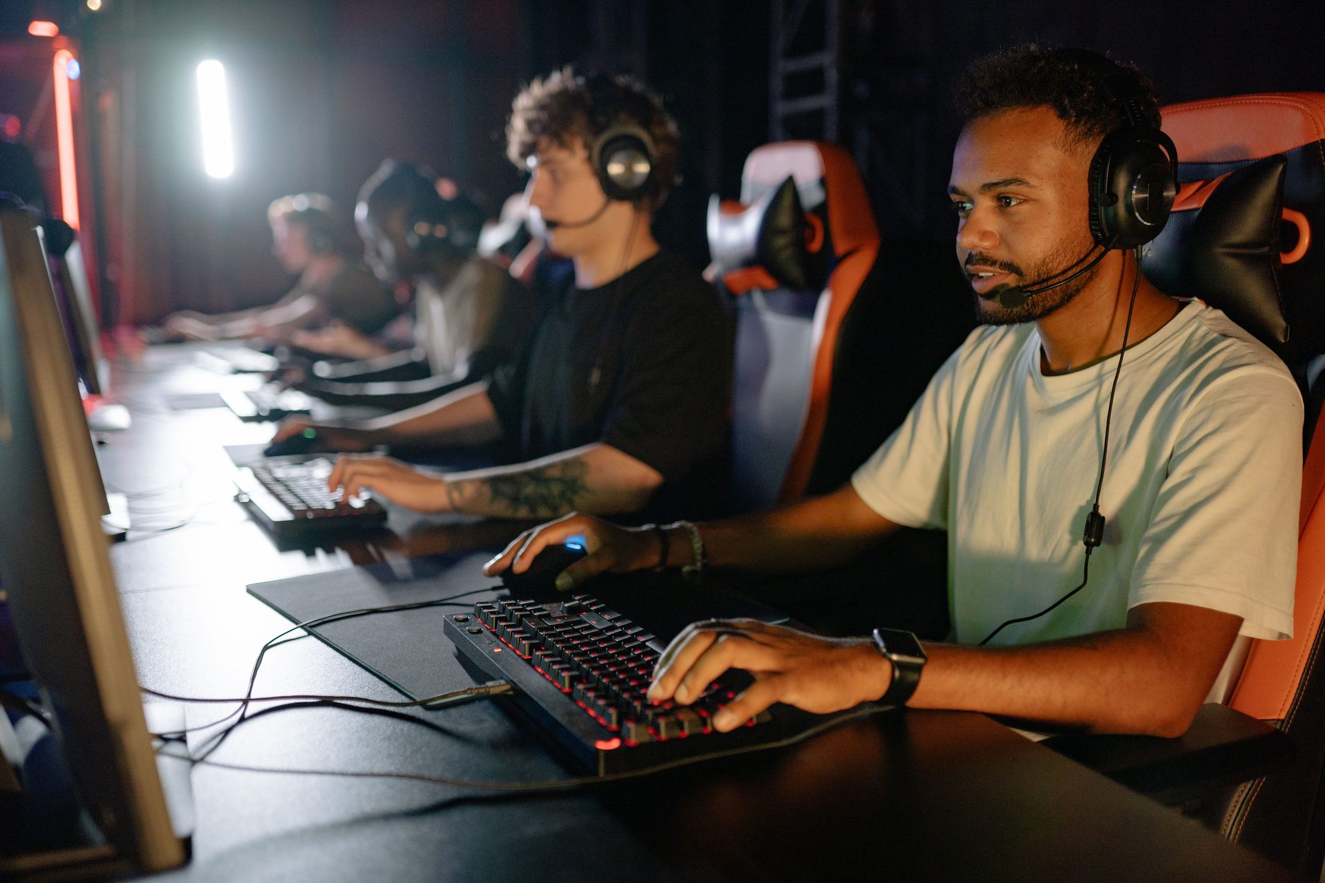 Neon-lit YOYO gaming floor glowing fuchsia during a busy evening session